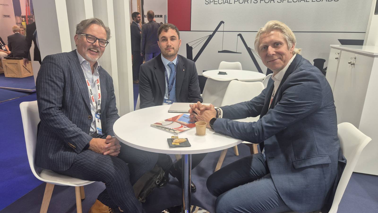 Inphiz in conversation at a port stand during Breakbulk